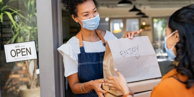 customer taking her food order at its doorstep